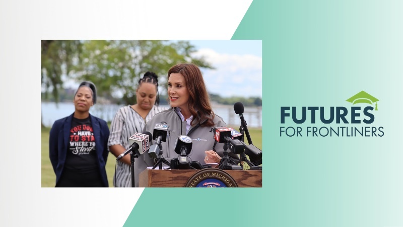 Governor Gretchen Whitmer speaking at podium with Futures for Frontliners logo to the right