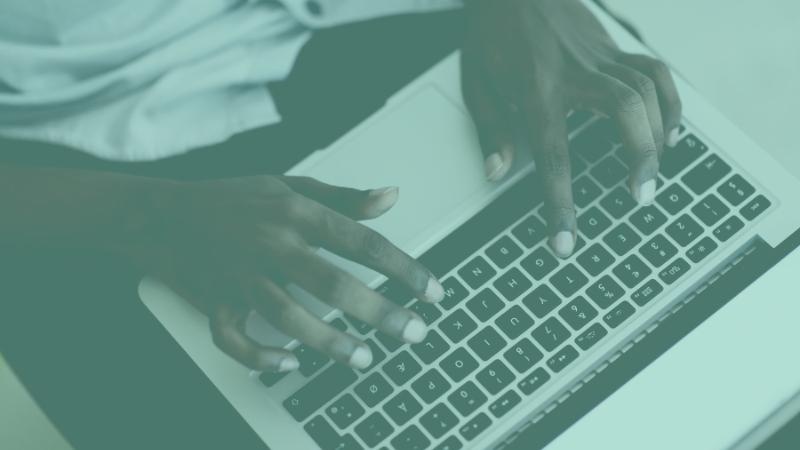 Photo of hands on a laptop keyboard