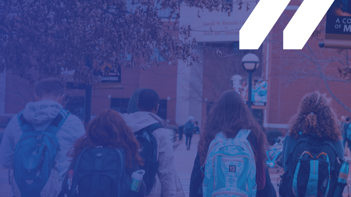 Students walking toward a school, MCAN logo upper right corner