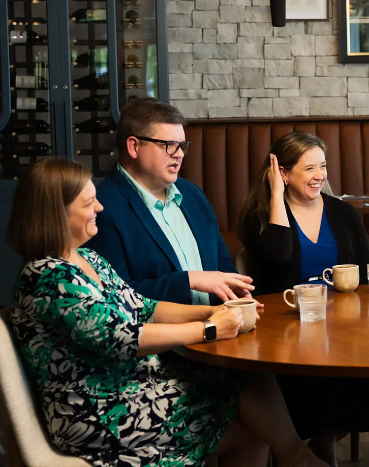 Ryan Frewins-Bliss sitting at a table with others
